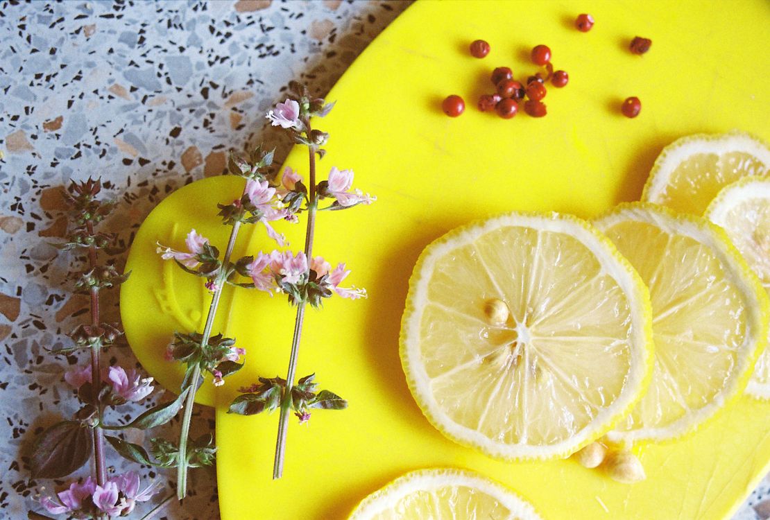 Fresh herbs and lemons on a cutting board
